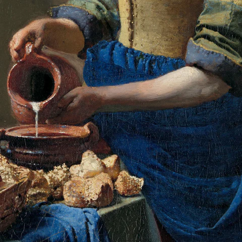 Melkstraal en aardewerk in Het Melkmeisje van Johannes Vermeer